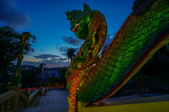 Colorful naga statue at dusk.