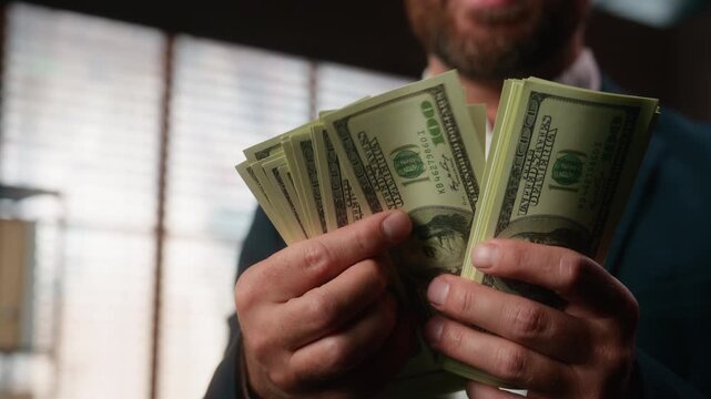 Unrecognizable positive Caucasian business man counting cash money smiling male hands holding dollar bills stack calculating count income happy specialist salesman with earnings savings economy growth