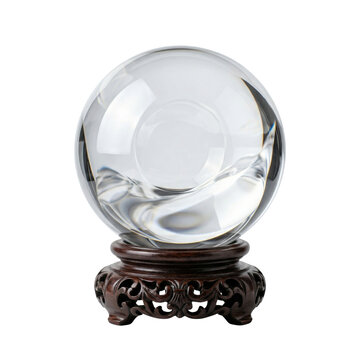 Clear crystal ball on ornate wooden stand isolated. Fortune telling concept.