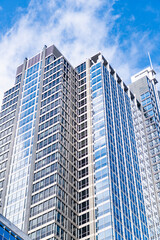 Fototapeta premium Business city. City architecture. Modern glass building. Reflective glass architecture. Architecture business district. Building architecture. Business building. Glass building. Urban business core