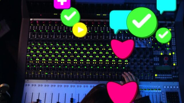 Audio engineer adjusting faders and knobs in studio right hand activating icons showing engagement