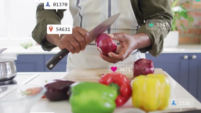 Male cook peeling and slicing onion, drawing reaction bubbles around knife, produce in cooking demo