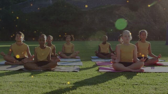 Children sitting on yoga mats after guide cue practicing health as sunlight creating green flare