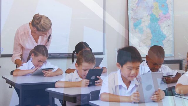 Teacher moving along rows, leaning over students after tablet tapping, offering guidance by map