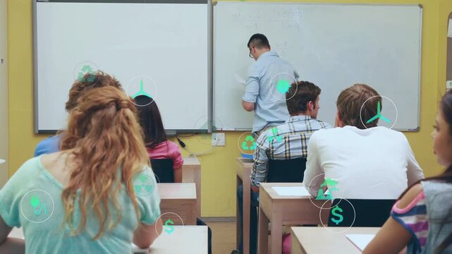 Instructor wearing blue shirt khakis writing on board with students noting green icons, copy space