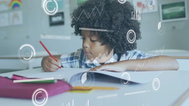 Male student opening workbook and writing with red pencil doing classwork while HUD charts floating