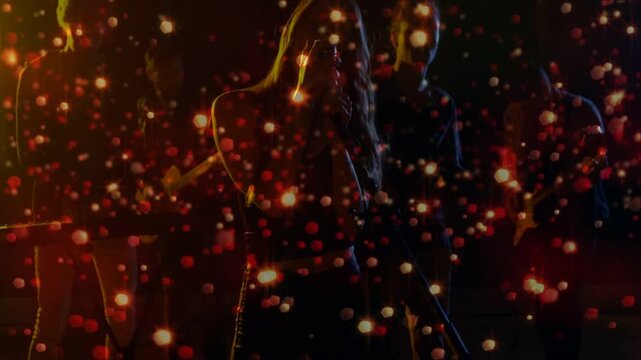 Camera opening singer moving to mic and singing to perform live, particle overlay pulsing over band