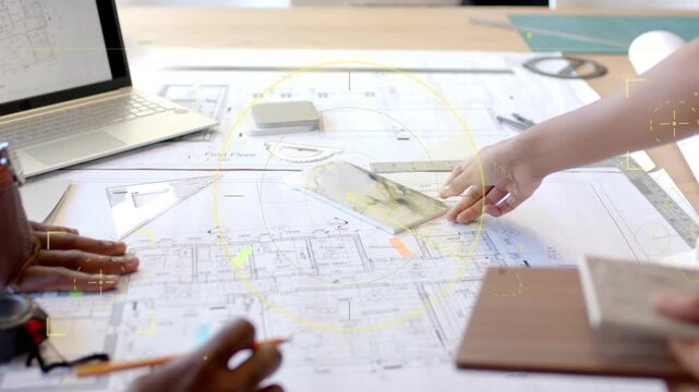 Male architect and female designer placing tile and wood samples on blueprint, comparing finishes