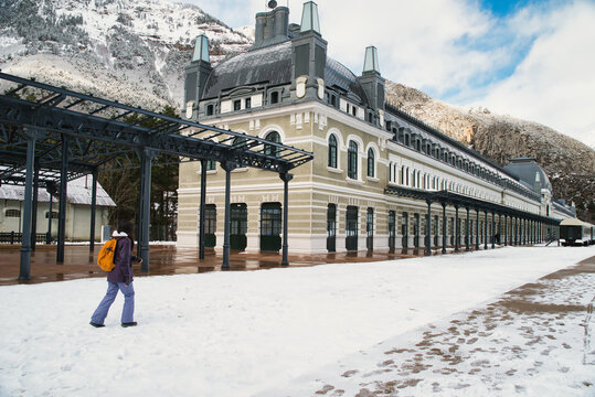 A girl walking at the Canfranc International Station, covered in snow, in the Aragonese Pyrenees; it opened in 1928 in Huesca, Spain, on the border with France.
