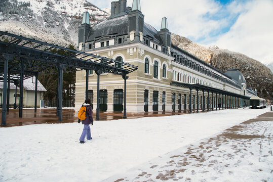 A girl walking at the Canfranc International Station, covered in snow, in the Aragonese Pyrenees; it opened in 1928 in Huesca, Spain, on the border with France.
