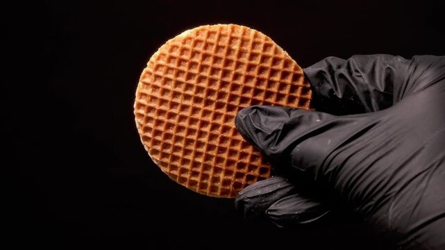 4K 4x Slow Motion Black Glove Turning Stroopwafel toward Camera