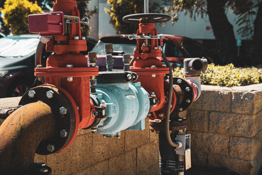 Industrial water valves and pipes with a weathered, utilitarian aesthetic