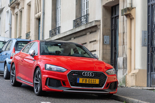 Nancy, France - January 17th 2019 : View on a red Audi RS5 Coup&eacute; finished in Misano Red parked on a street with cars behind and buildings in the background.