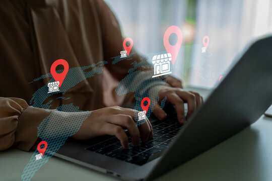 A woman works intently on her laptop, surrounded by digital maps and location pins, symbolizing the connection between technology and global business expansion. Gantry