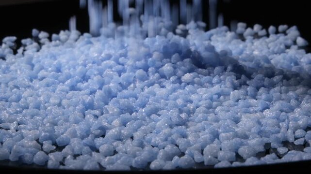 4K 4x Slow Motion Blue Candy Pellets Pouring on Black Background