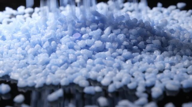 4K 4x Slow Motion Vibrant Blue Pellets Pouring Profile Angle