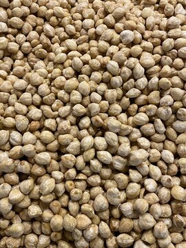 Top view full frame of peeled raw candlenuts (Aleurites moluccanus) pile at a traditional spice market