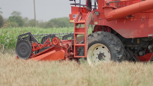 Slow Motion Multi Crop Combine Harvester Harvesting Crops in Rural Field 