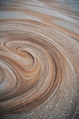 Obraz premium Wavy sand dune patterns formed by wind erosion. Natural desert landscape texture. Abstract background for environmental conservation and nature photography concepts. vertical format