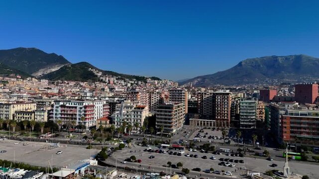 Aerial drone footage showing the Salerno coastline from above, highlighting the meeting point of city and sea.