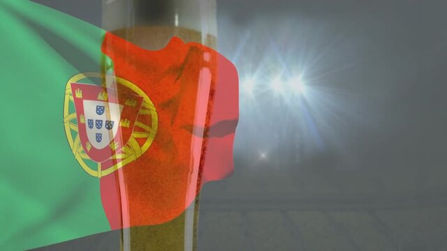 Tall drinking glass centered, Portugal flag entering from left, waving over glass for display