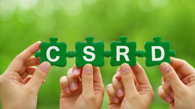 Hands holding CSRD puzzle pieces against a green background. A concept shot of environmental responsibility and policy. Sustainable business, responsible practices.