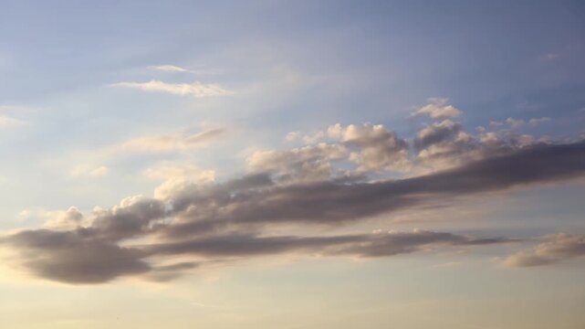 Dramatic white clouds moving fast across the bright blue sky in a cinematic nature timelapse