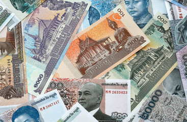 Cambodian riel money banknotes pile on table. Cambodia bills of KHR currency close up © Larysa