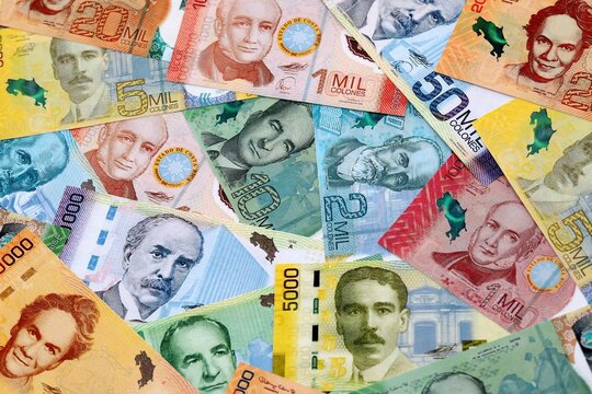 Costa Rican colon money banknotes pile on table. Costa Rica bills of CRC currency close up
