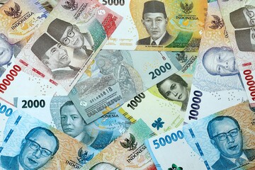 Indonesian rupiah money banknotes pile on table. Indonesia bills of IDR currency close up © Larysa