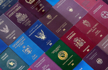 Big amount of passport covers from many biometrical passports close up. Travel concept © Larysa