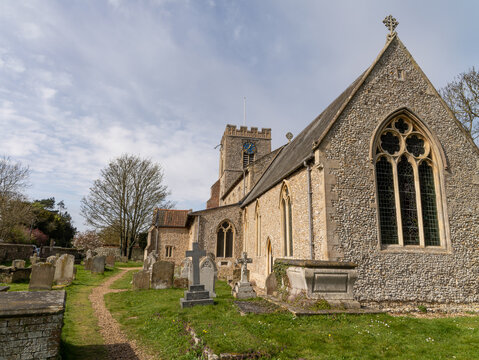Quaint rural village St Marys Church Westgate, Burnham Market. Quintessential Stone building English village church and cemetery on a summers afternoon.