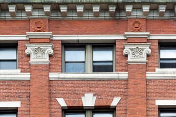 Historic red brick facade in Cambridge featuring white Ionic capitals on brick pilasters  © Baharlou