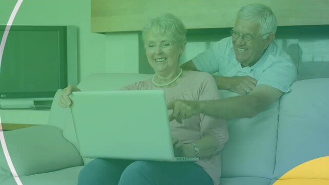 Animation of shapes over senior caucasian couple using laptop