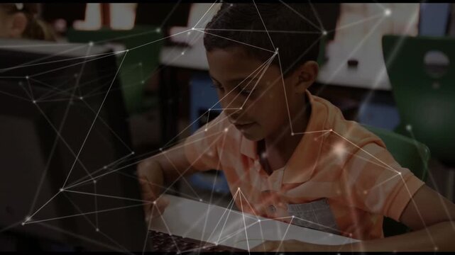 Schoolboy placing hands on keyboard, following prompts while typing with technology overlay