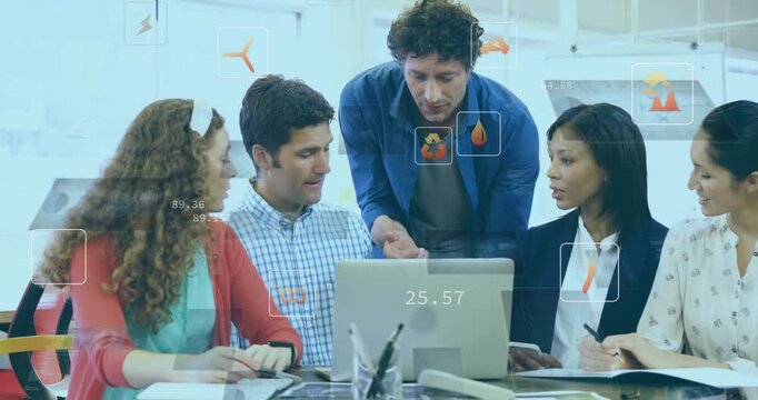 Man in blue shirt pointing at laptop and initiating animated energy icons while team analyzing data