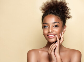 Beauty portrait of african american woman with clean healthy skin on beige background. Smiling dreamy beautiful afro hairstyle  girl.Curly afro  black hair © Sofia Zhuravetc