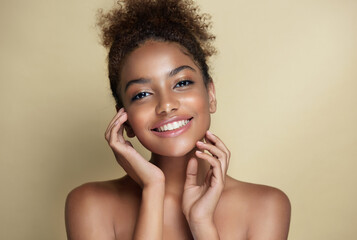 Beauty portrait of african american woman with clean healthy skin on beige background. Smiling dreamy beautiful afro hairstyle  girl.Curly afro  black hair © Sofia Zhuravetc