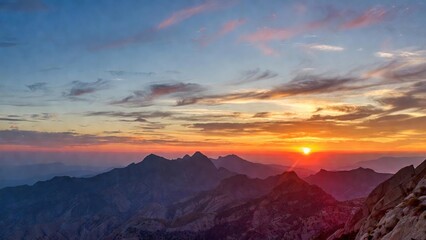 Obraz premium Distant peaks framed by colorful twilight sky at sunset