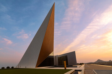 Oman Across Ages Museum with striking modern architecture captured at sunset highlighting geometric design and dramatic sky. Oman - April 8 2026 © Salim