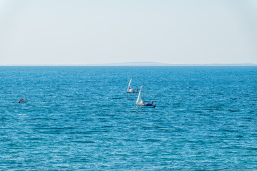 Naklejka premium Sailing yacht in the blue calm sea.
