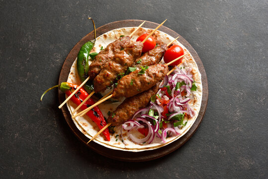 Grilled lula kebab with fresh vegetables on flat bread