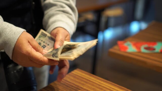 payment debt money banking on JPY Yen banknote in hands finance wealth
