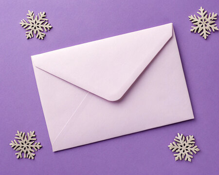 Elegant Pastel Envelope Mockup on Purple Winter Background with Snowflakes
