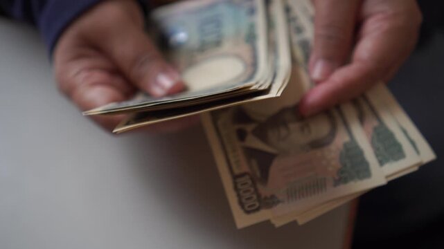 Counting JPY money Japanese Yen banknote pay shopping payment services