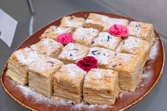 Sliced Napoleon cake with layered puff pastry and cream