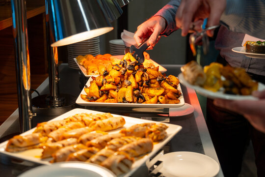 Guests serving roasted potato with mushroom and grilled chicken rolls