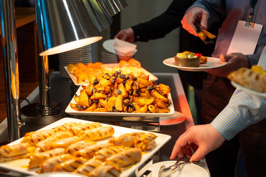 Guest serving roasted potato with mushroom and salad