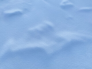 Obraz premium Soft blue snow texture with gentle ridges and shadows. Perfect for winter backgrounds, calming interfaces, or serene design projects. Subtle gradient highlights add depth