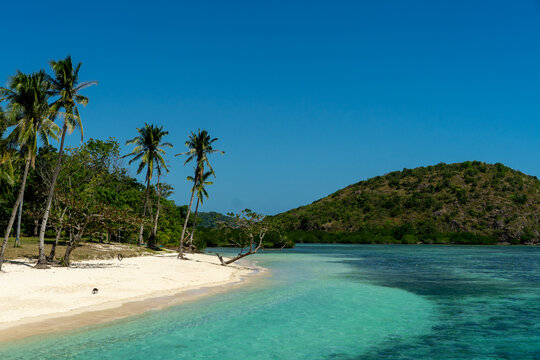 Araw Beach beautiful landscape with white sand, pristine water and palms near Culion, Palawan, The Philippines.